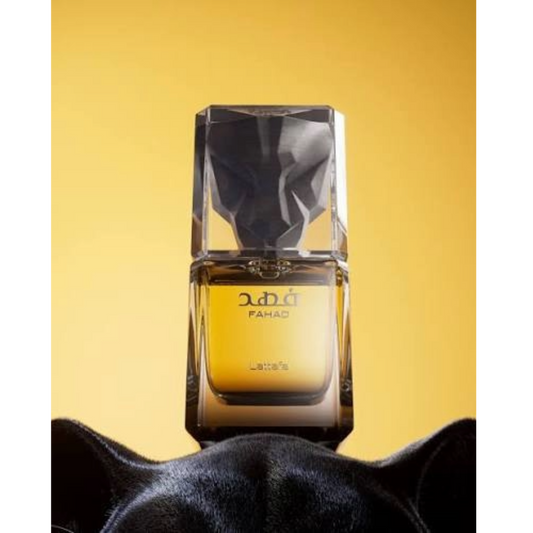 Lattafa Fahad perfume bottle with a faceted black cap, set against a solid yellow background with a black cat's ears visible at the bottom.