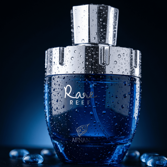 Afnan Rare Reef bottle in a closeup shot with water droplets on with a blue background 