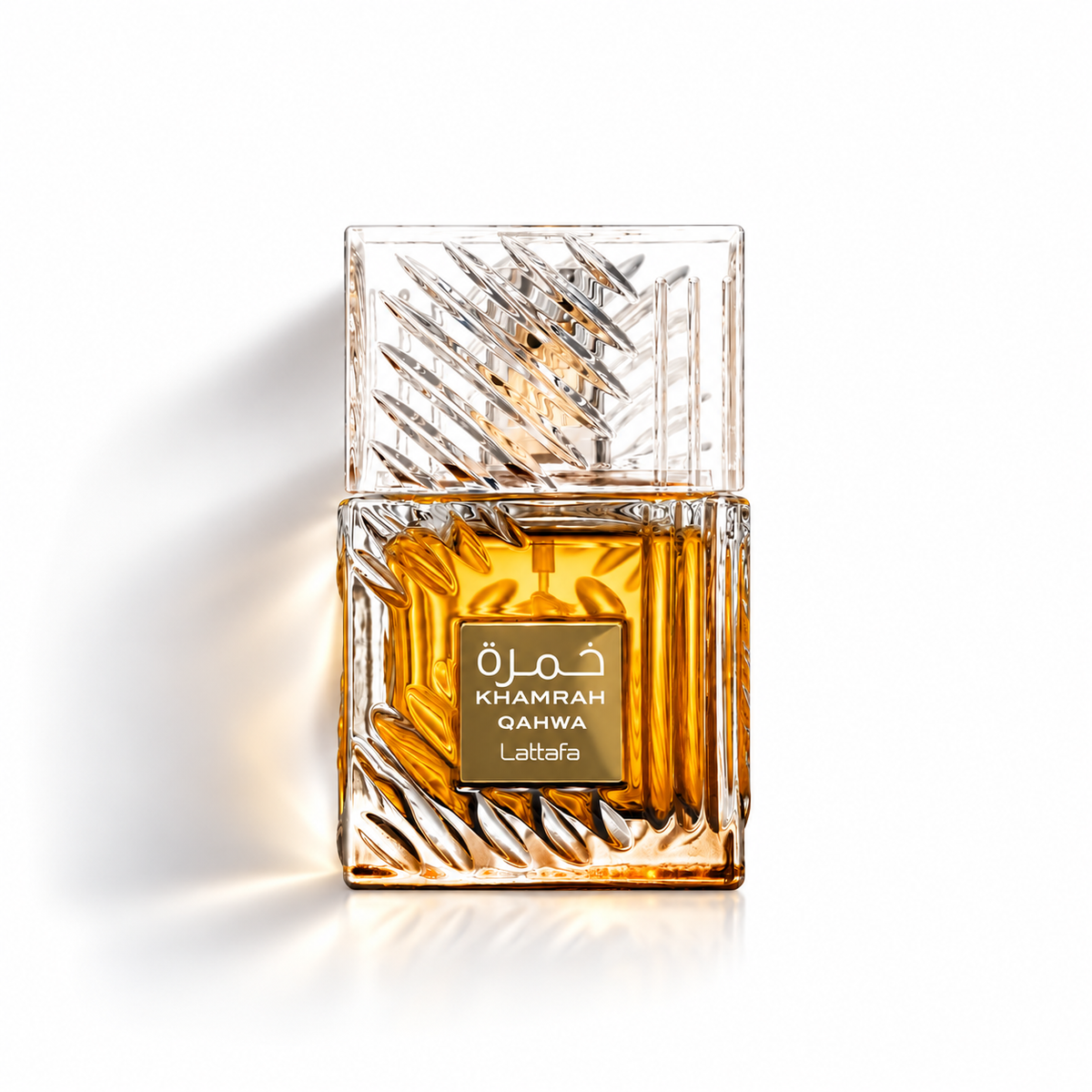 Lattafa Khamrah Qahwa Eau de Parfum bottle with faceted clear glass, amber fragrance and gold label on a white background with soft shadow.