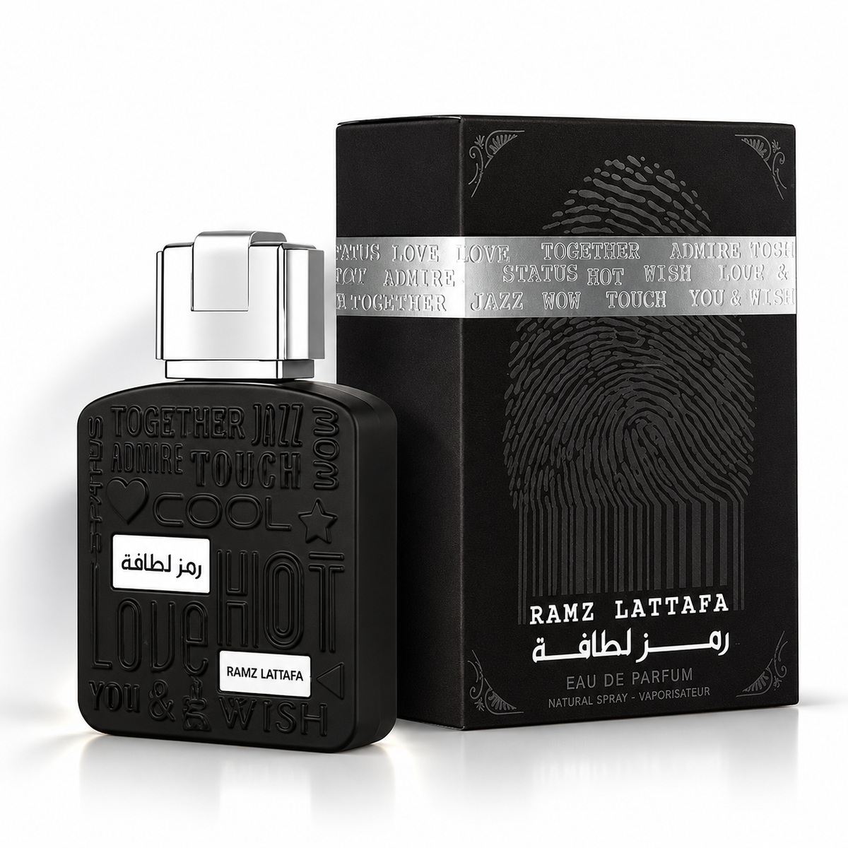 Lattafa Ramz Silver Eau de Parfum black perfume bottle with silver cap beside its matching black fingerprint-design box on a clean white background with soft shadows.