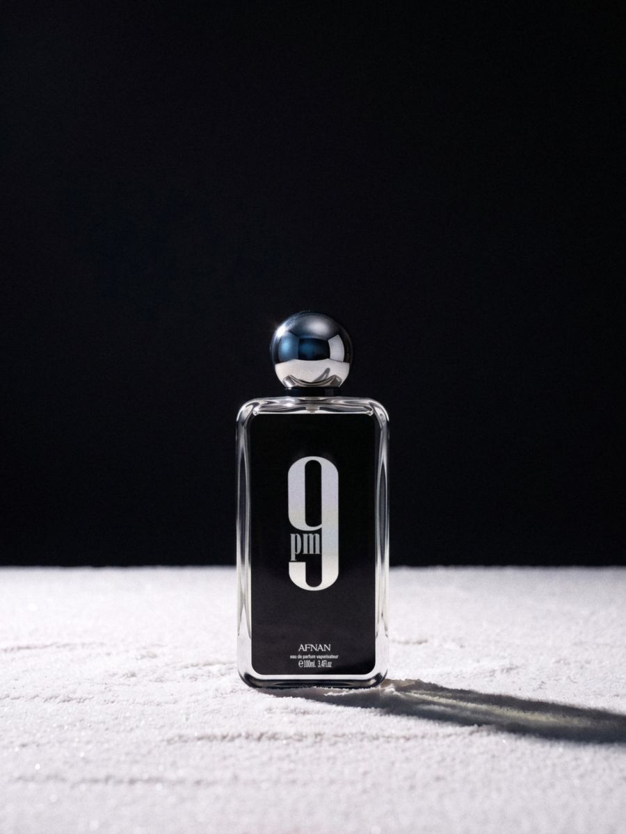 Afnan 9pm on a white salt floor against a black studio backdrop